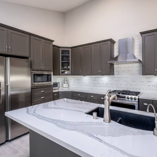 dark gray cabinets with white countertops